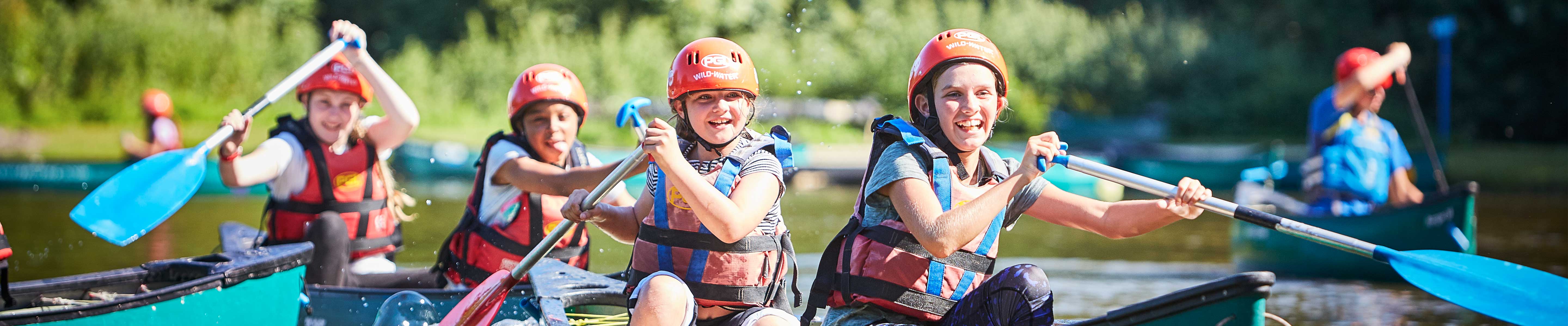 A teacher canoeing with her students at PGL